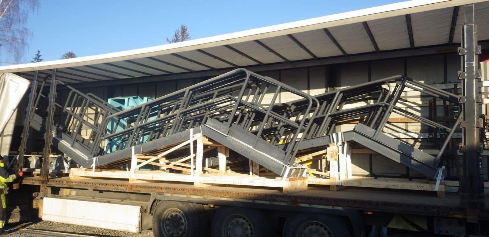 Steel frames stacked on an open curtainsider trailer