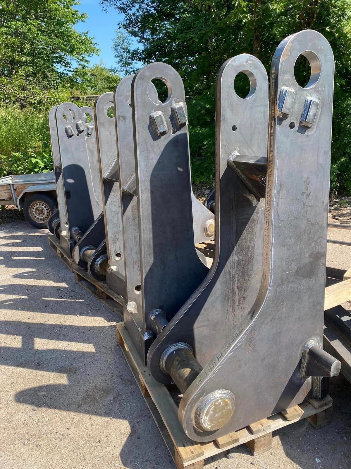 Heavy cut steel brackets with lifting eyes, strapped on a trailer
