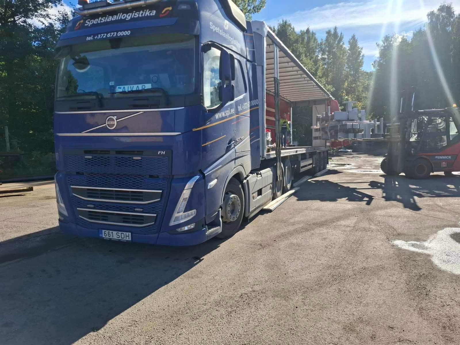 Blue Volvo truck being loaded by forklift at the Novatex yard in Tallinn
