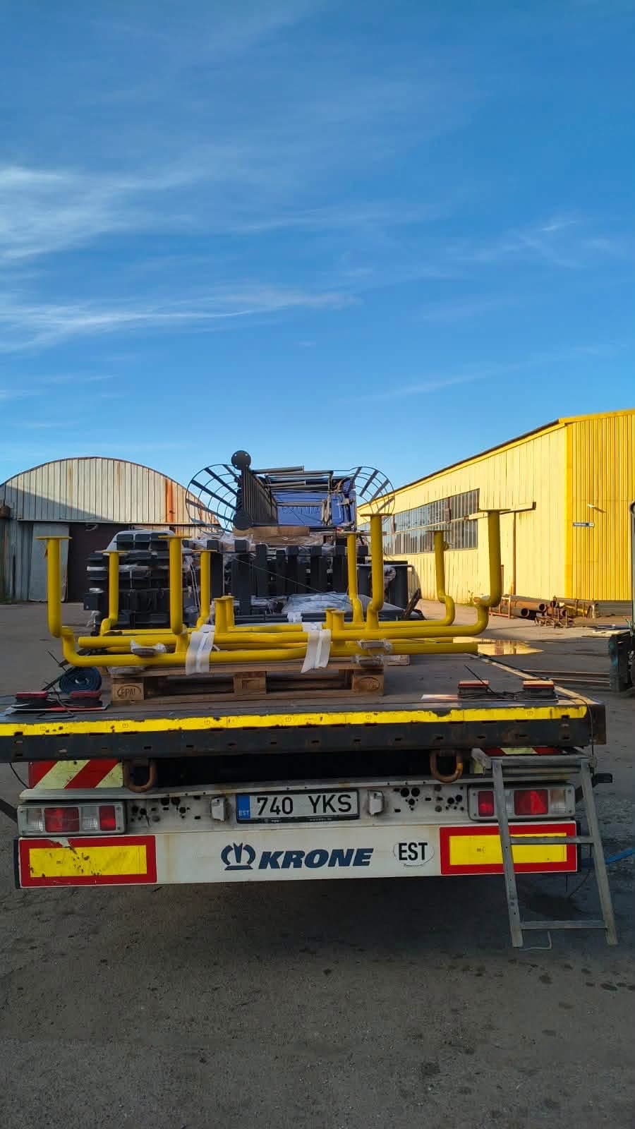 Rear of a Krone flatbed carrying a yellow painted steel frame at the Novatex yard in Tallinn