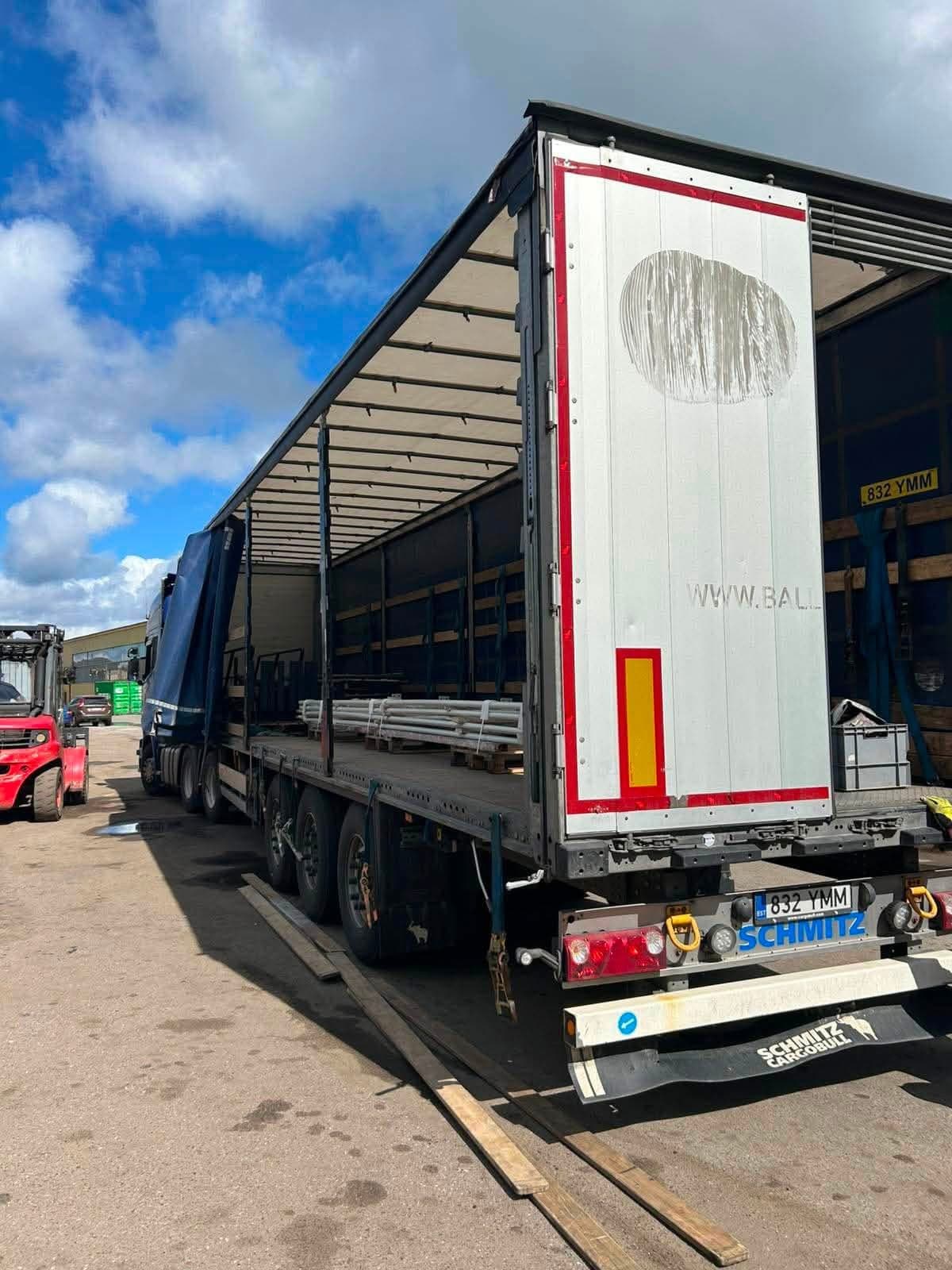 Rear of a Schmitz curtainsider trailer during loading with a forklift at the Novatex yard in Tallinn