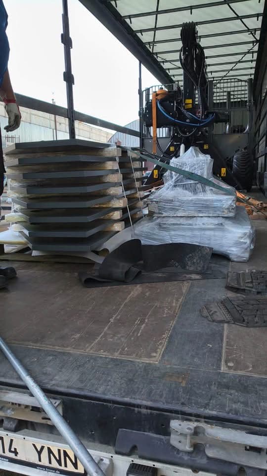 Stacks of cut steel plates loaded inside a curtainsider trailer at the Novatex yard in Tallinn
