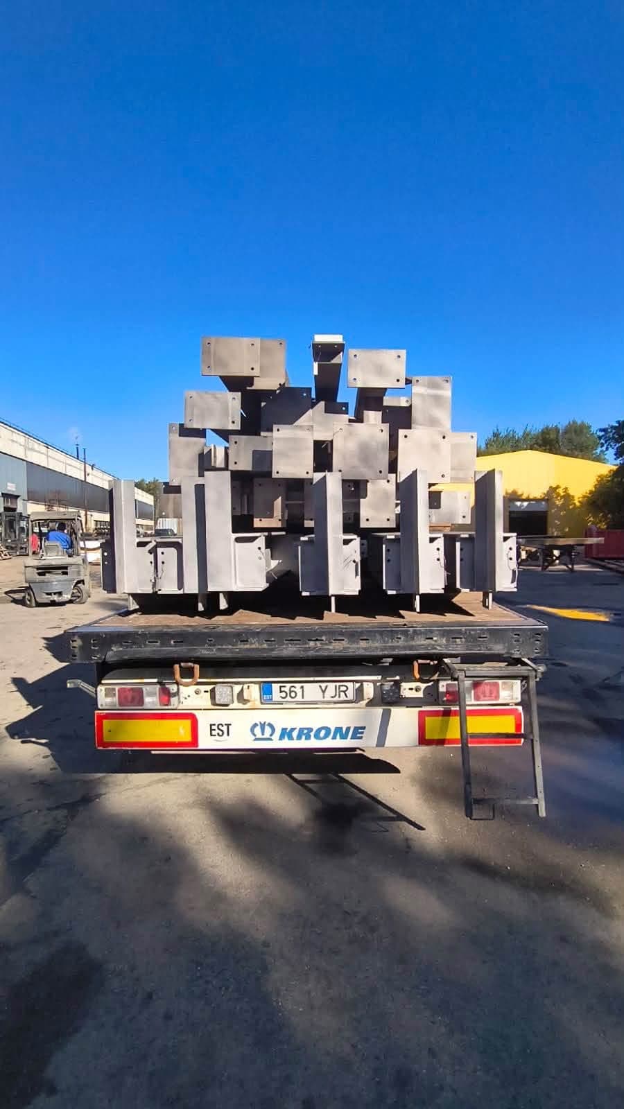 Rear view of steel columns with base plates stacked on a flatbed at the Novatex yard in Tallinn