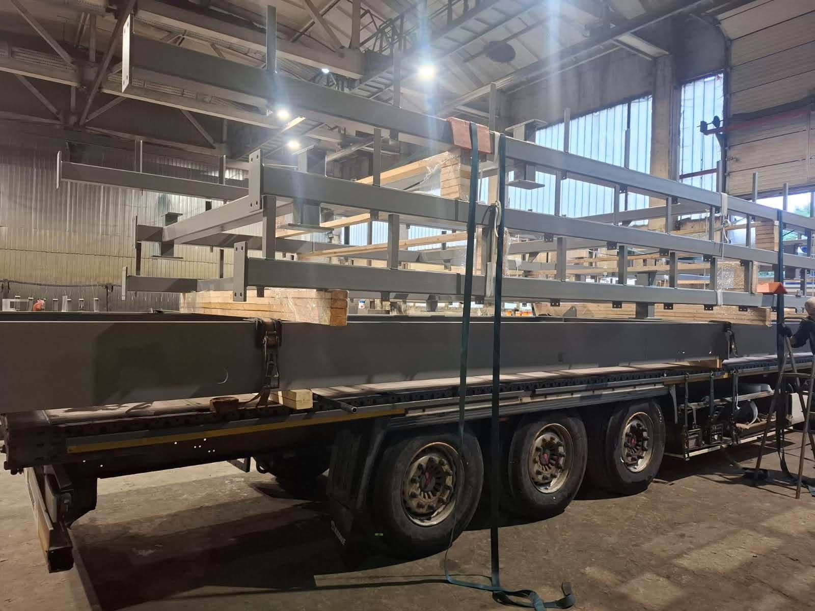 Steel frames loaded on a flatbed trailer inside the Novatex workshop